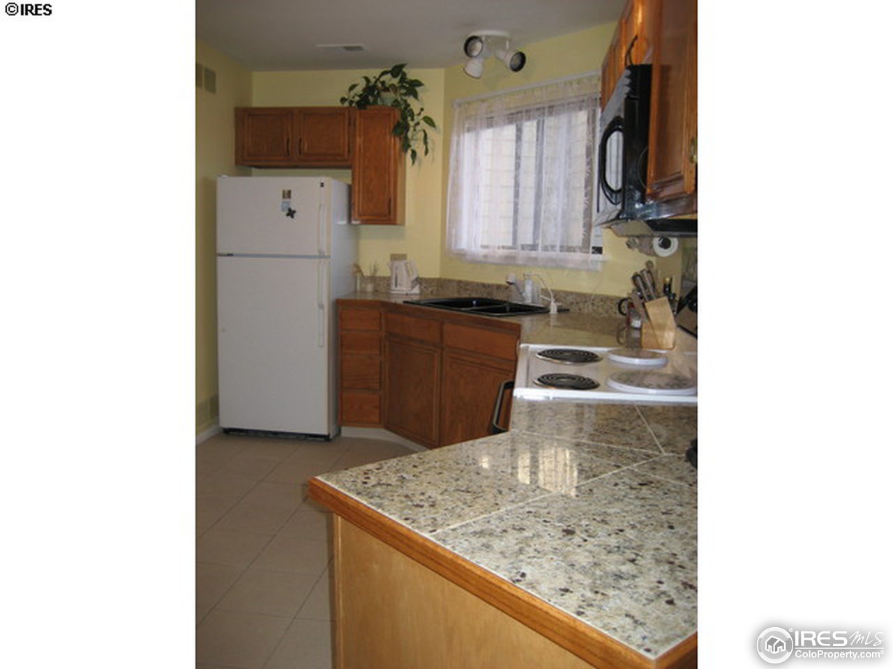 4965 Twin Lakes Road, Unit 64 Boulder, CO 80301 - Photo 3 of 6 a kitchen with a sink and cabinets
