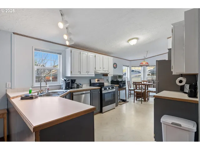 a kitchen with sink a counter space and appliances
