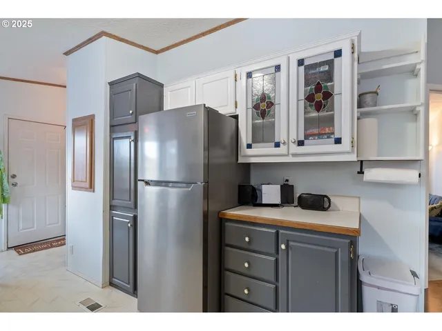 a kitchen with stainless steel appliances granite countertop a refrigerator and a cabinets