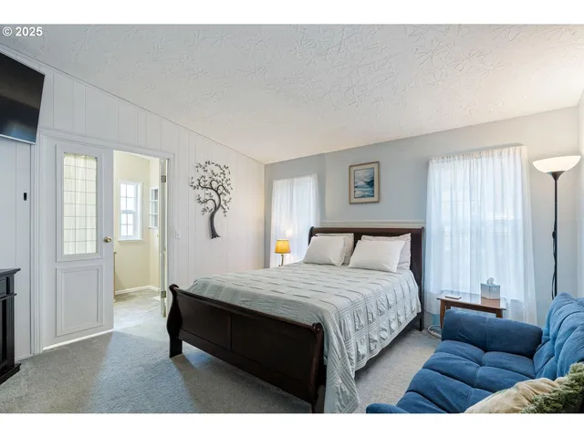 a bedroom with a bed couch and window