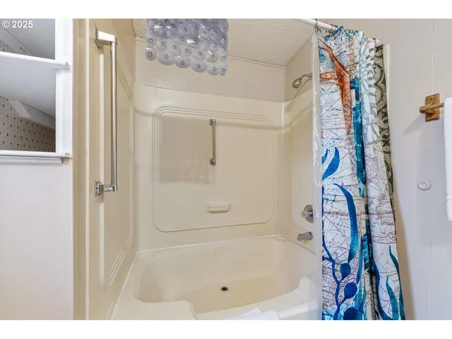 a bathroom with a bathtub and shower