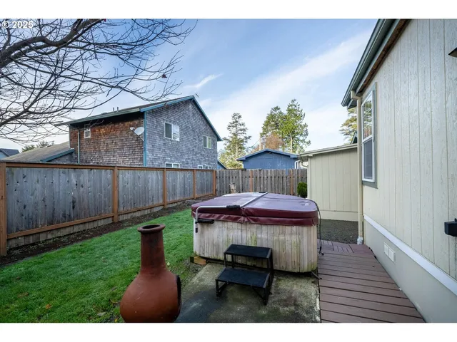 a view of a backyard with wooden fence
