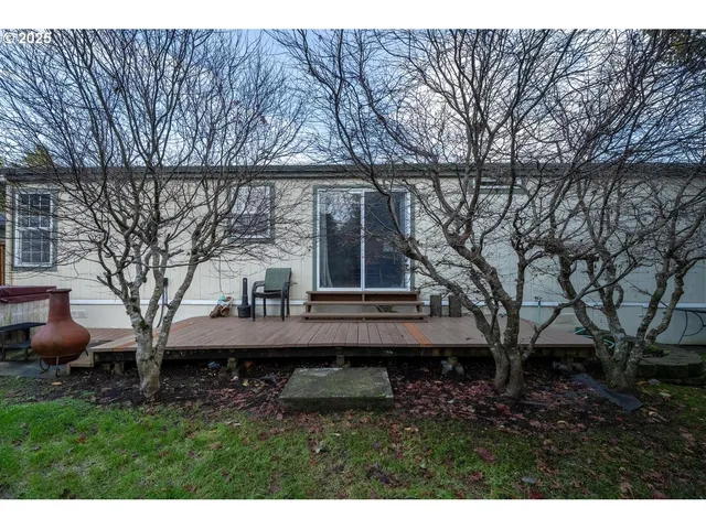 a view of backyard with a table and chair under an umbrella