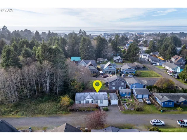 an aerial view of residential houses with outdoor space and swimming pool