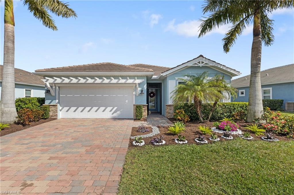14837 Windward Lane Naples, FL 34114 - Photo 2 of 45 a front view of a house with a yard