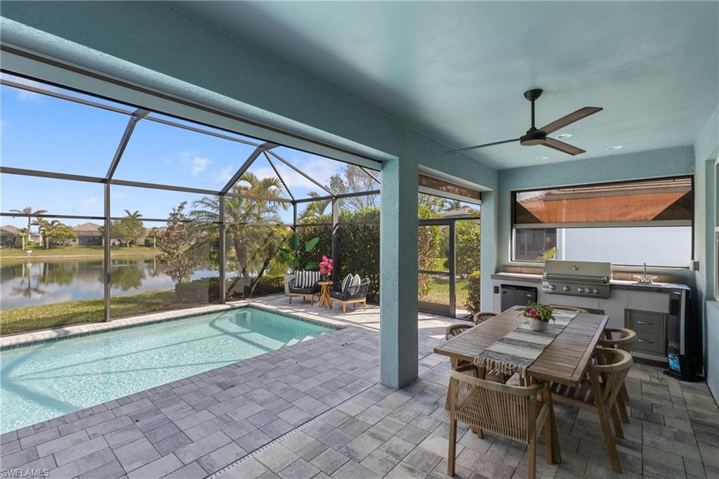 14837 Windward Lane Naples, FL 34114 - Photo 21 of 45 a living room with a floor to ceiling window and an outdoor dining table