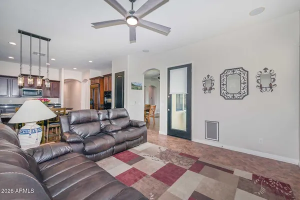 a kitchen with stainless steel appliances kitchen island granite countertop a refrigerator and a stove top oven