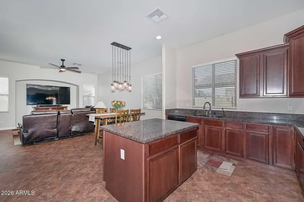 a kitchen with granite countertop cabinets stainless steel appliances and a counter space