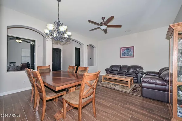 a living room with furniture a chandelier and a window