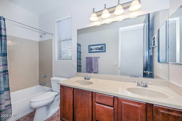 a bedroom with a bed and ceiling fan