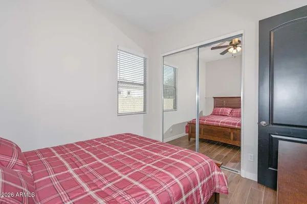 a bedroom with a bed and wooden floor