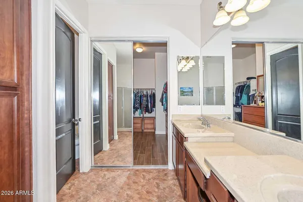 a spacious bathroom with a granite countertop double vanity sink mirror and bathtub