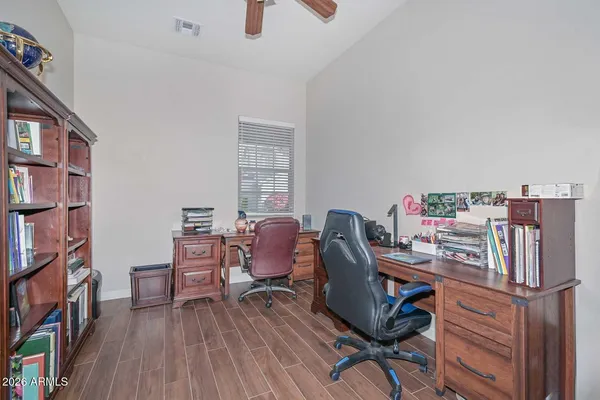 a view of a workspace with furniture and a book shelf