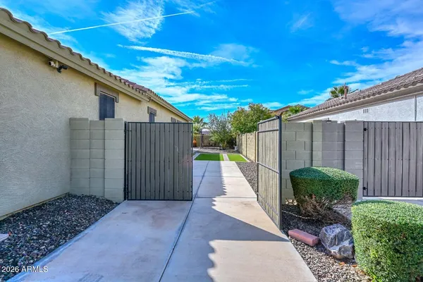 a view of a backyard with plants and a patio