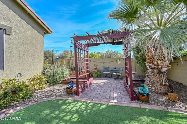 a view of a patio with table and chairs and potted plants