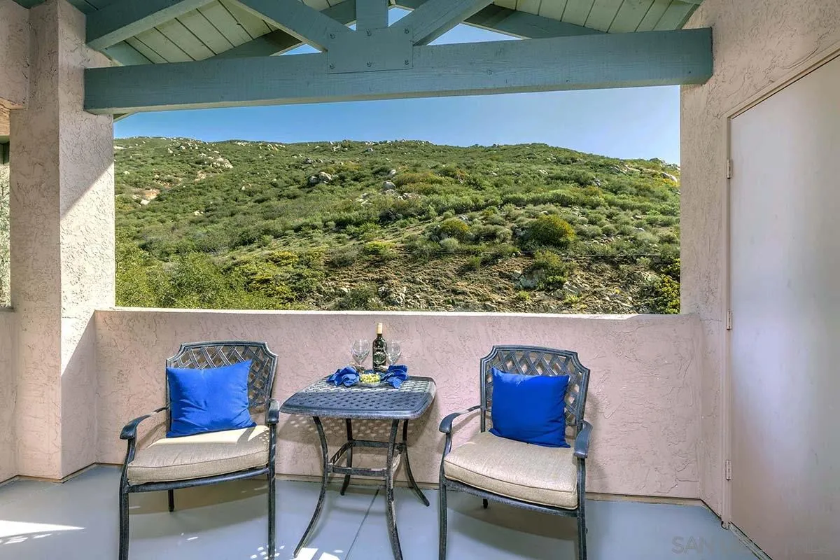 a view of a balcony with chair and table