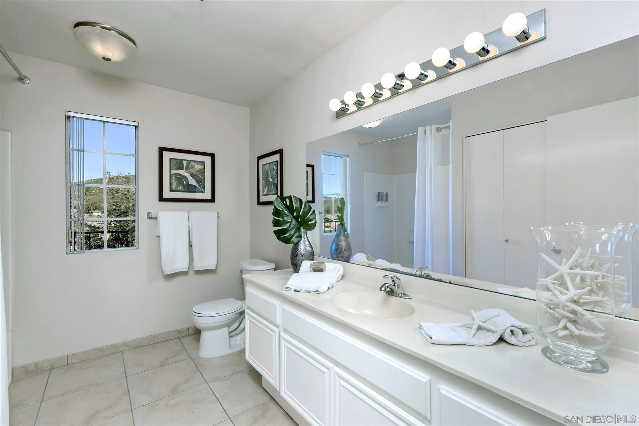17161 Alva Road, Unit 931 San Diego, CA 92127 - Photo 13 of 30 a bathroom with a granite countertop double vanity and a mirror