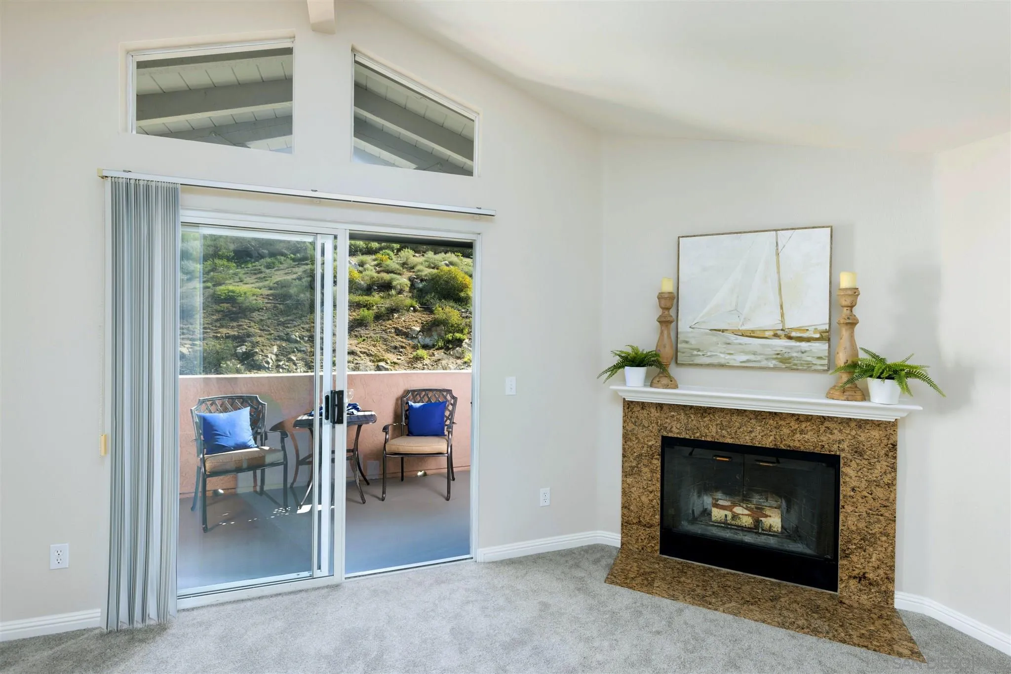 17161 Alva Road, Unit 931 San Diego, CA 92127 - Photo 3 of 30 a living room with a fireplace and a floor to ceiling window