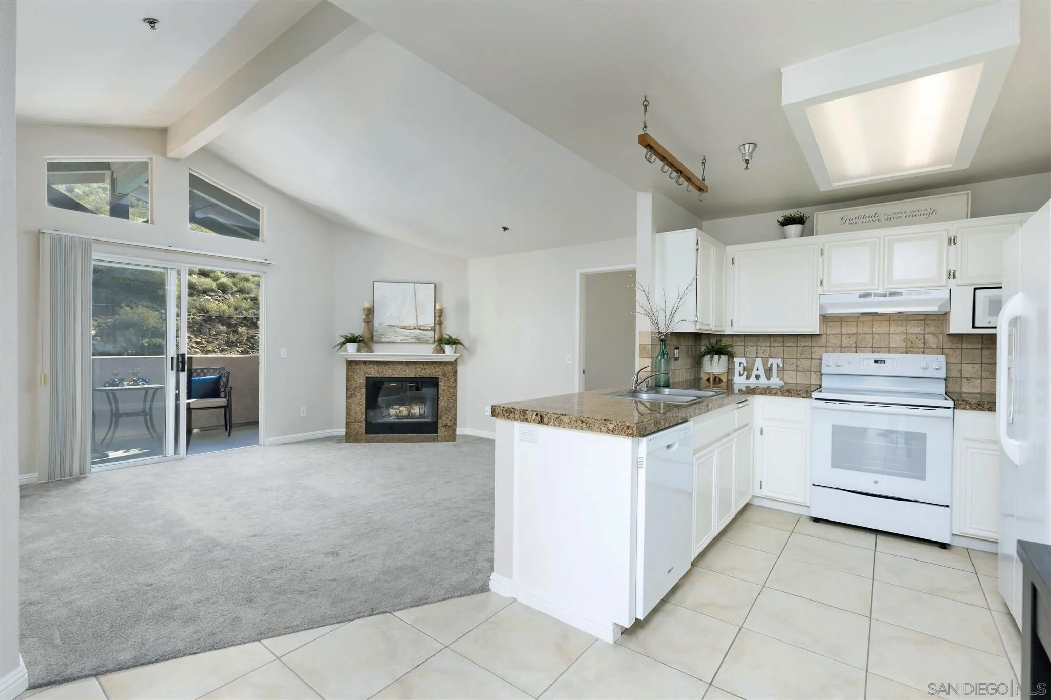 17161 Alva Road, Unit 931 San Diego, CA 92127 - Photo 6 of 30 a kitchen with granite countertop a stove top oven and cabinets