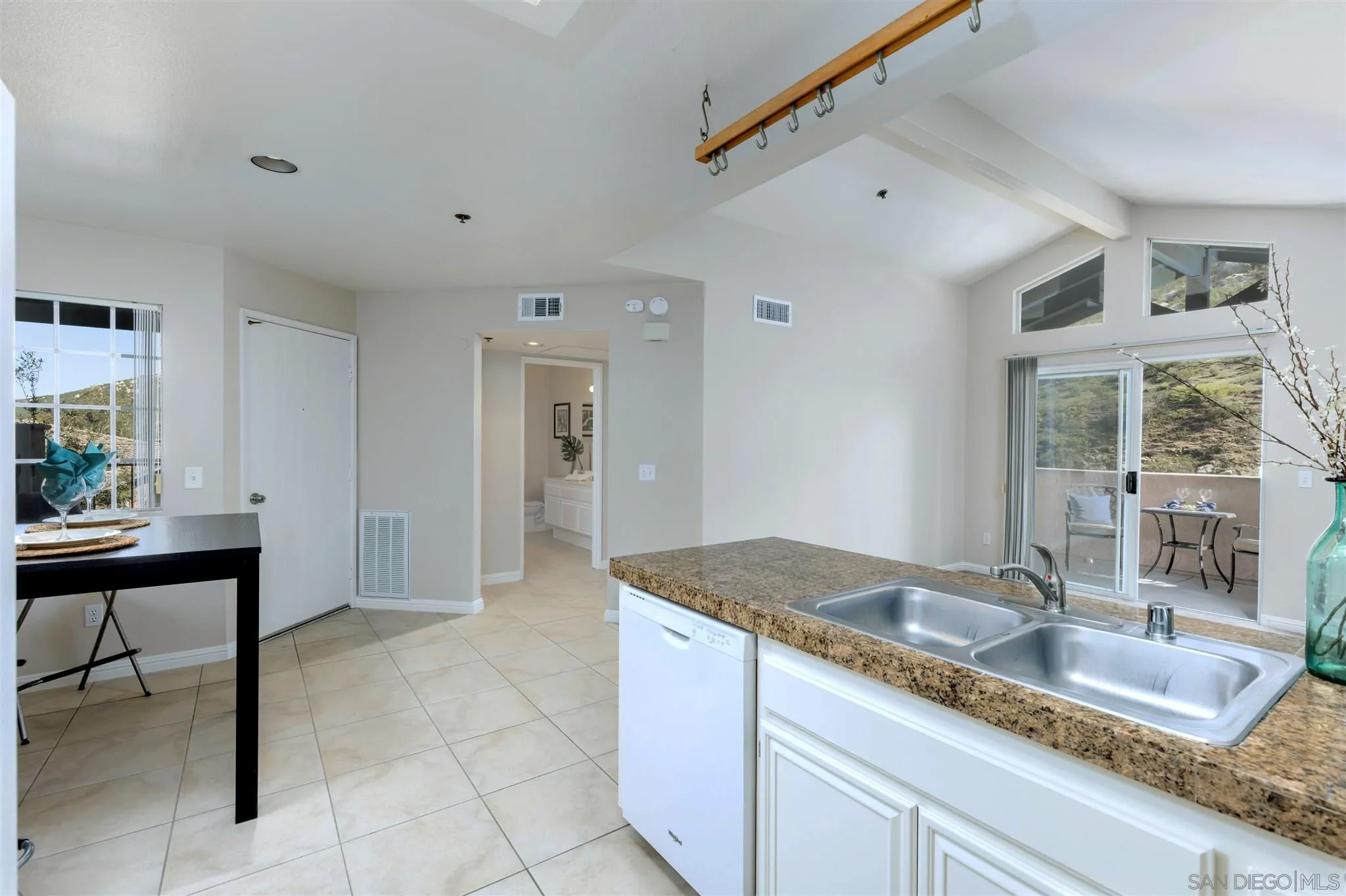 17161 Alva Road, Unit 931 San Diego, CA 92127 - Photo 8 of 30 a kitchen with granite countertop a sink a stove and cabinets