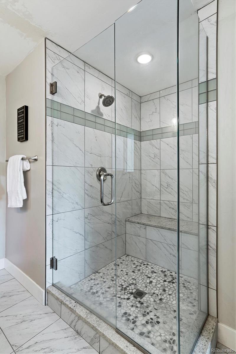 28867 Cedar Circle Evergreen, CO 80439 - Photo 12 of 35 a bathroom with a shower and a sink