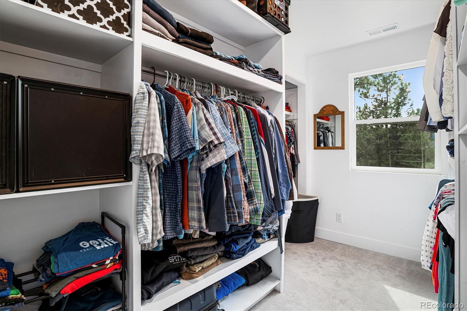 28867 Cedar Circle Evergreen, CO 80439 - Photo 13 of 35 a view of walk in closet with clothes and shoes