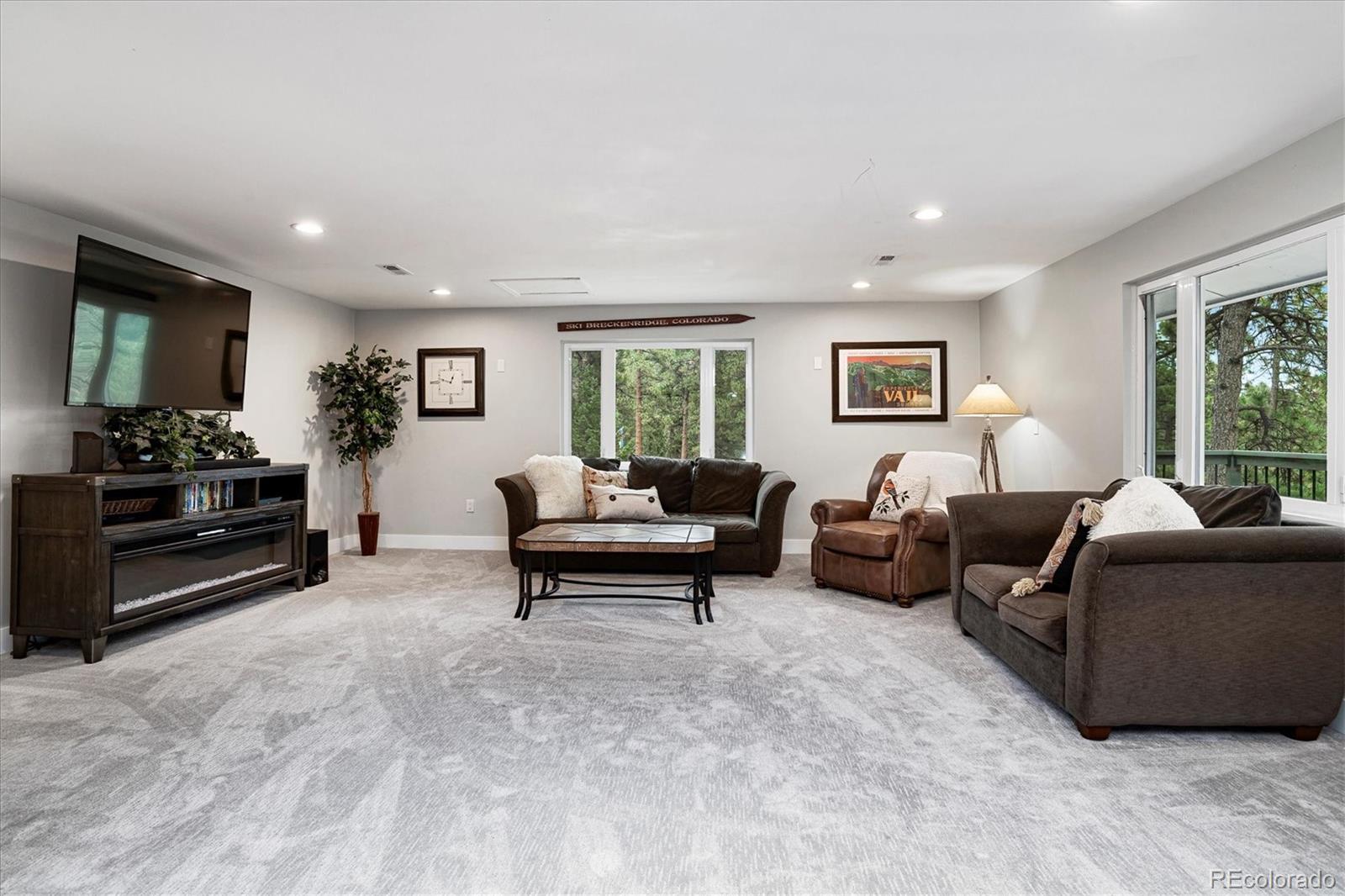 28867 Cedar Circle Evergreen, CO 80439 - Photo 19 of 35 a living room with furniture and a flat screen tv
