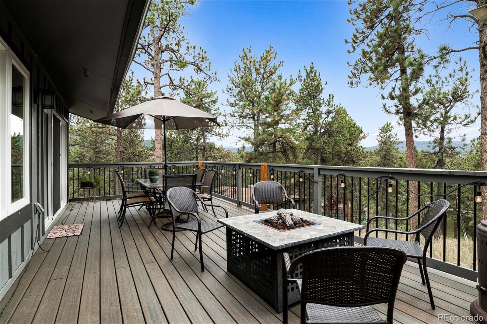 28867 Cedar Circle Evergreen, CO 80439 - Photo 27 of 35 a view of a roof deck with table and chairs