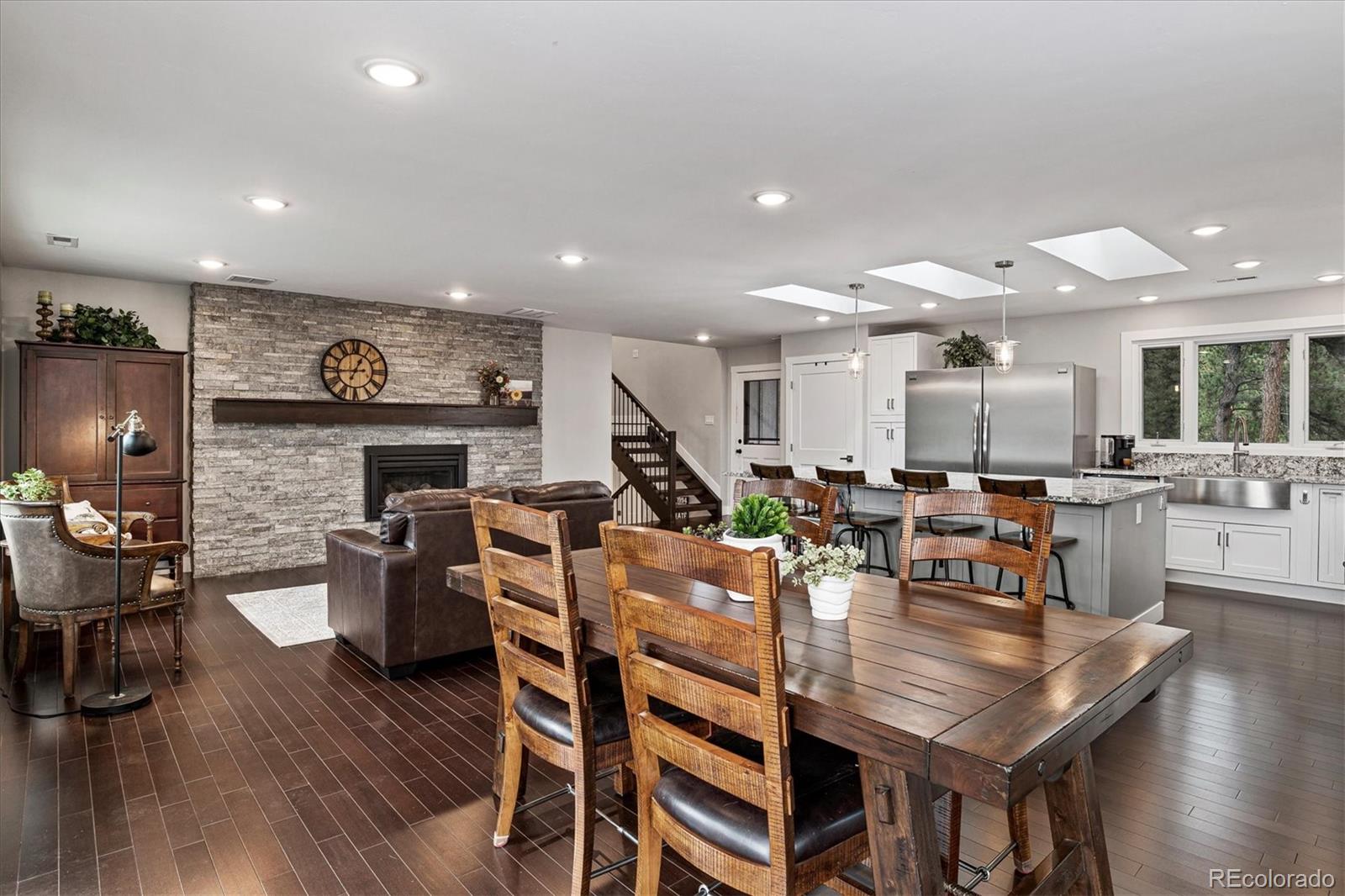 28867 Cedar Circle Evergreen, CO 80439 - Photo 6 of 35 a living room with fireplace furniture and a wooden floor