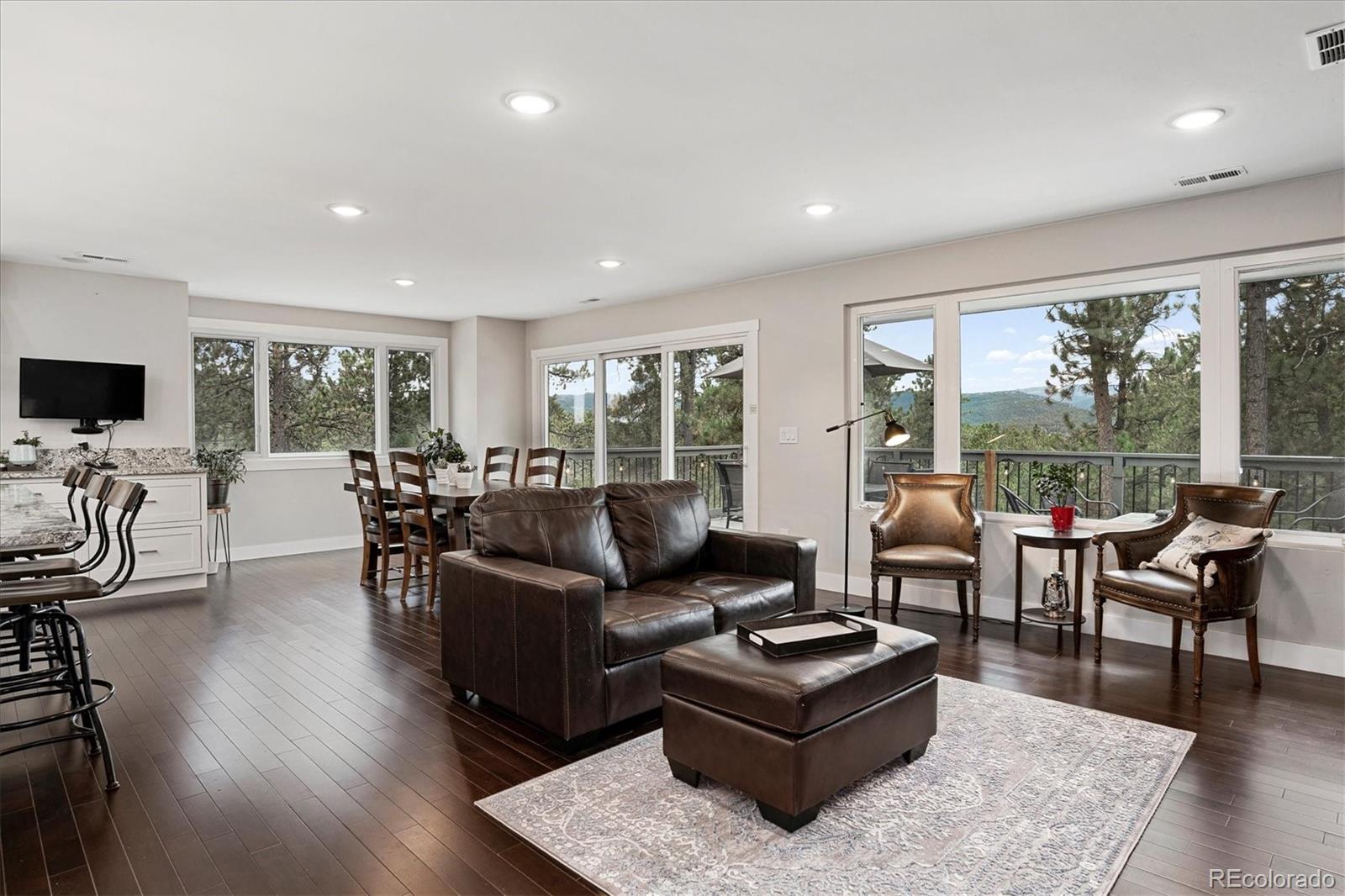 28867 Cedar Circle Evergreen, CO 80439 - Photo 7 of 35 a living room with furniture and a flat screen tv