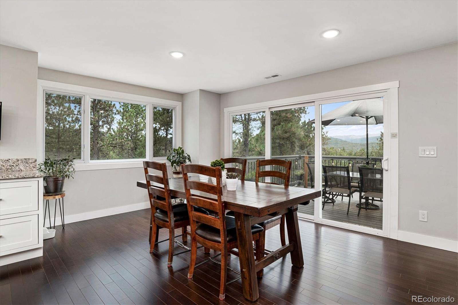 28867 Cedar Circle Evergreen, CO 80439 - Photo 9 of 35 a view of a dining room with furniture window and wooden floor