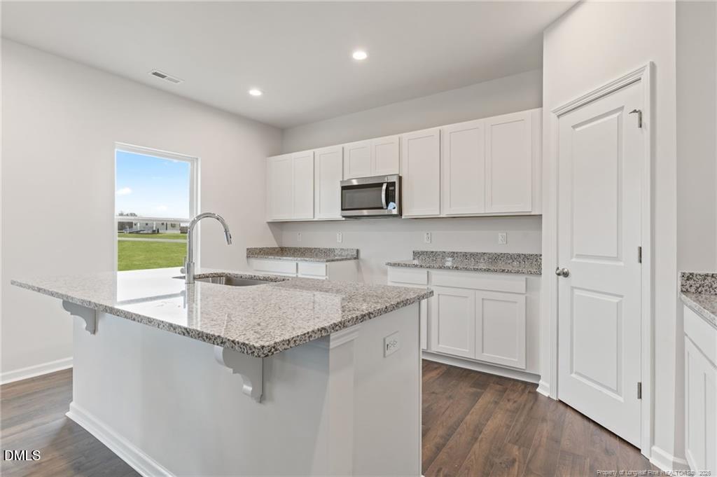 100 Rubyfield Court Fremont, NC 27830 - Photo 14 of 38 a kitchen with stainless steel appliances granite countertop a sink a stove and a refrigerator