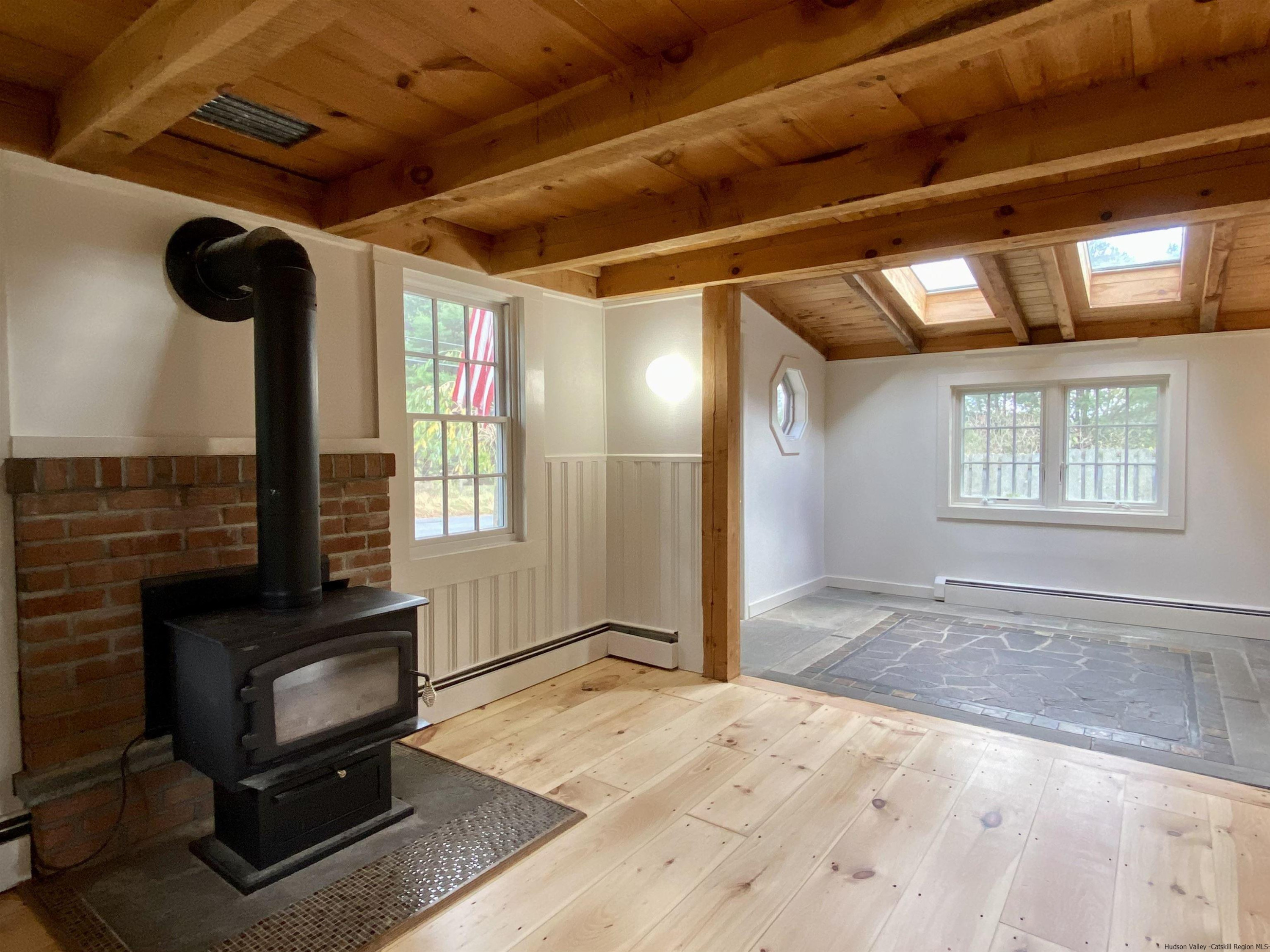 83 Palentown Road Kerhonkson, NY 12446 - Photo 17 of 30 a view of a livingroom with wooden floor and a fireplace
