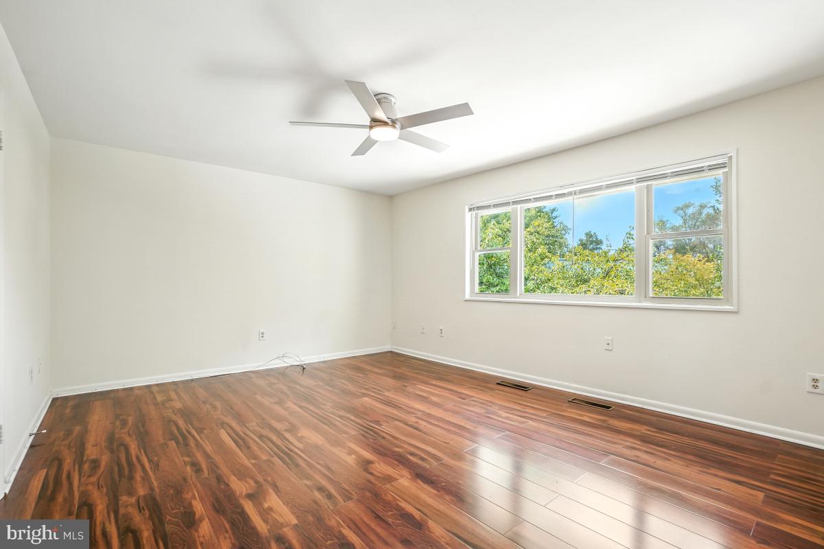 3434 Gleneagles Drive, Unit 78B Silver Spring, MD 20906 - Photo 23 of 31 a view of empty room with wooden floor and fan