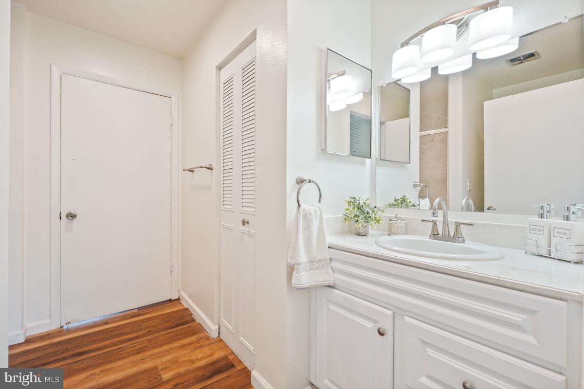 3434 Gleneagles Drive, Unit 78B Silver Spring, MD 20906 - Photo 25 of 31 a bathroom with a sink and a mirror