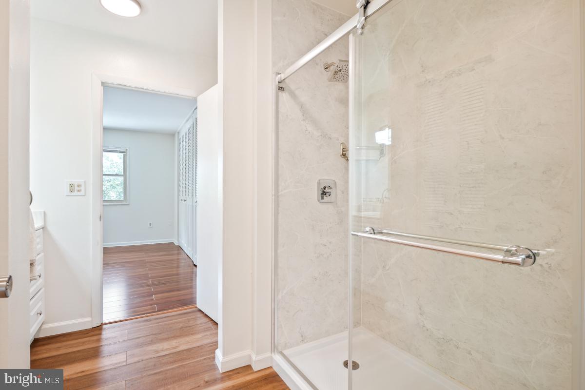 3434 Gleneagles Drive, Unit 78B Silver Spring, MD 20906 - Photo 26 of 31 a bathroom with a glass shower door