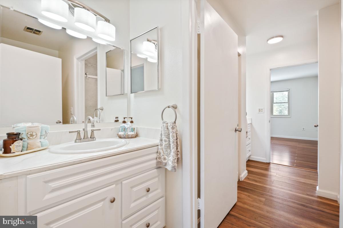 3434 Gleneagles Drive, Unit 78B Silver Spring, MD 20906 - Photo 27 of 31 a bathroom with a sink and a mirror