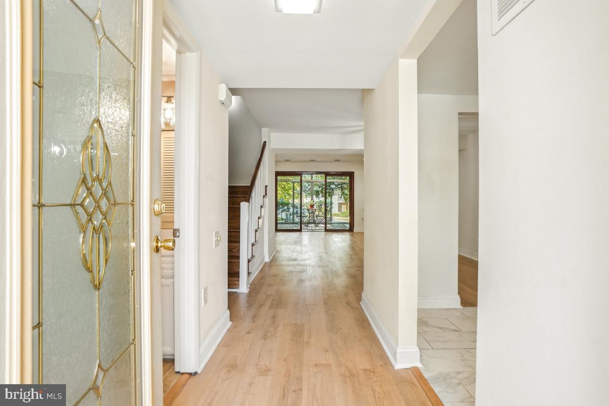 3434 Gleneagles Drive, Unit 78B Silver Spring, MD 20906 - Photo 4 of 31 a view of a hallway with wooden floor and a bathroom