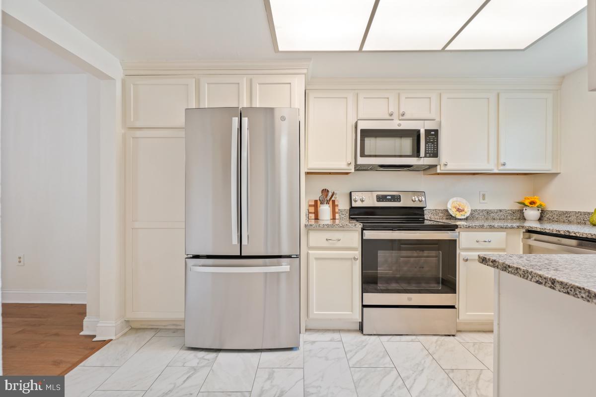 3434 Gleneagles Drive, Unit 78B Silver Spring, MD 20906 - Photo 7 of 31 a kitchen with a refrigerator stove and microwave