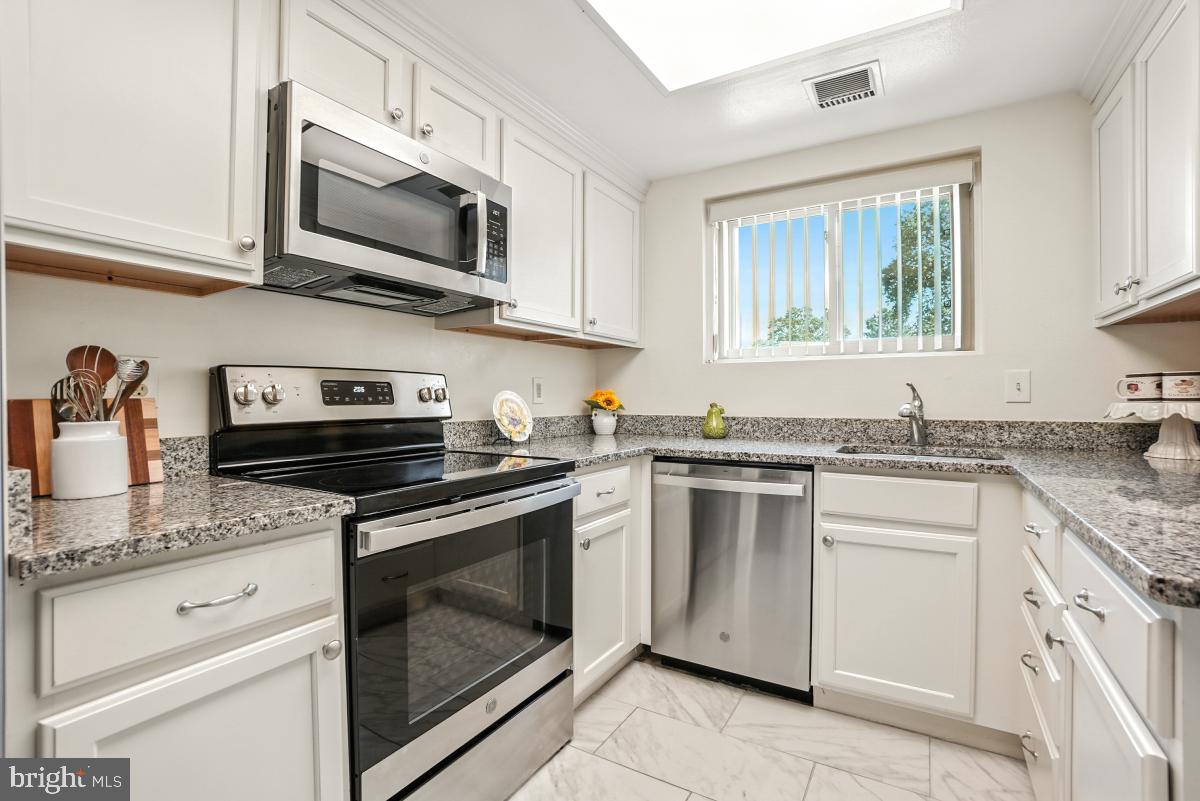 3434 Gleneagles Drive, Unit 78B Silver Spring, MD 20906 - Photo 9 of 31 a kitchen with cabinets stainless steel appliances and a sink