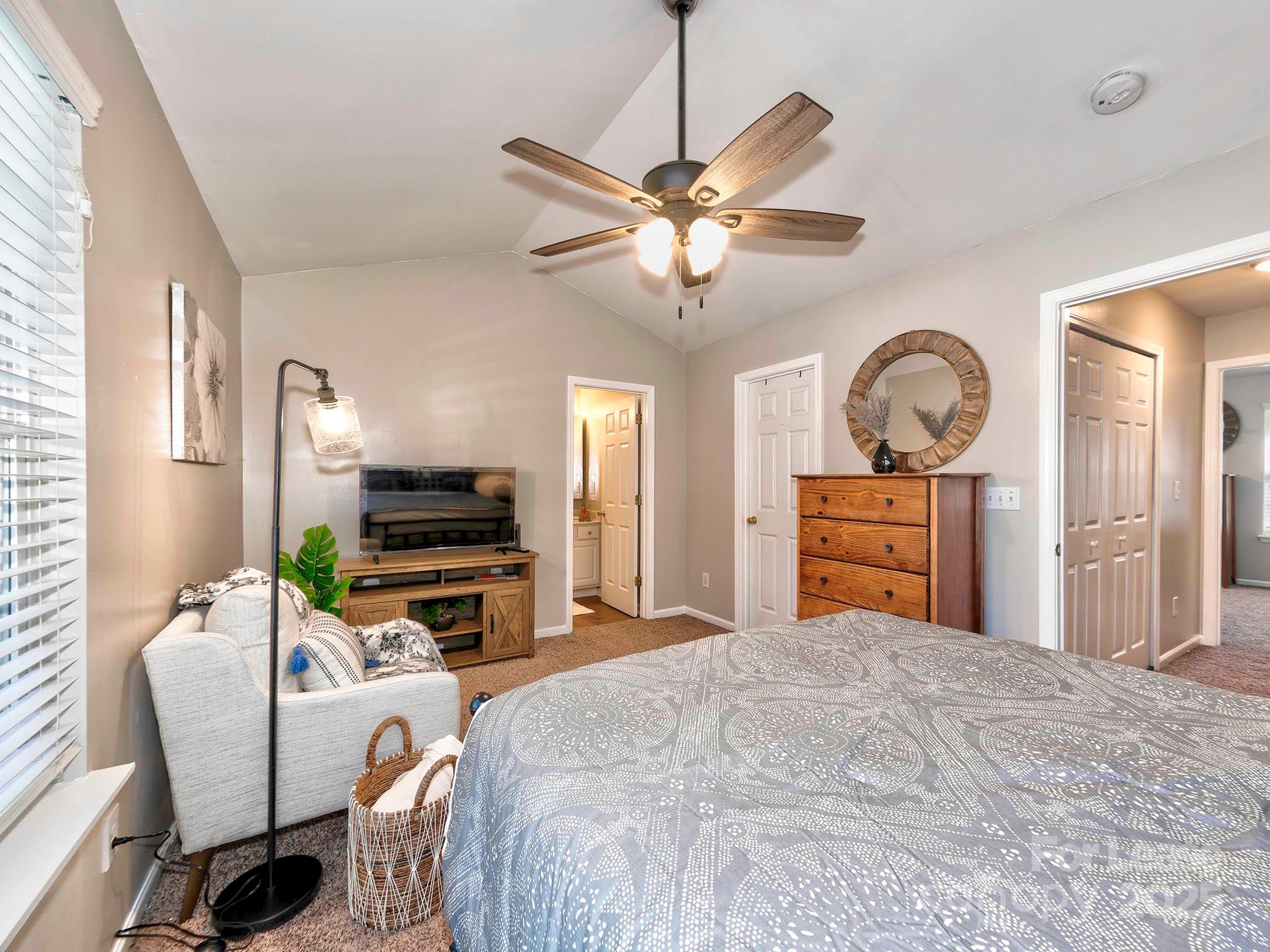 11316 Morgan Valley Lane Charlotte, NC 28270 - Photo 15 of 33 a bedroom with a bed dresser and a chandelier
