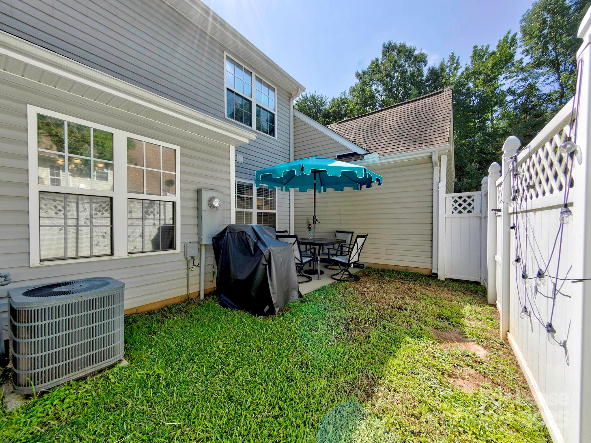 11316 Morgan Valley Lane Charlotte, NC 28270 - Photo 29 of 33 a view of a chair and table in backyard of the house
