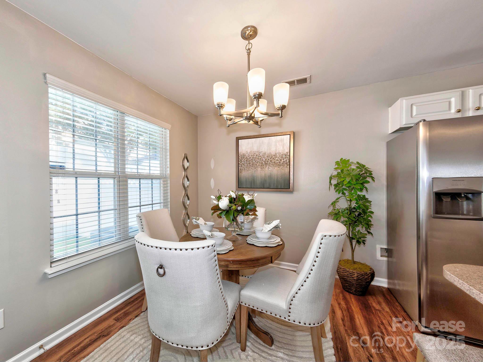 11316 Morgan Valley Lane Charlotte, NC 28270 - Photo 7 of 33 a view of a dining room with furniture window and wooden floor
