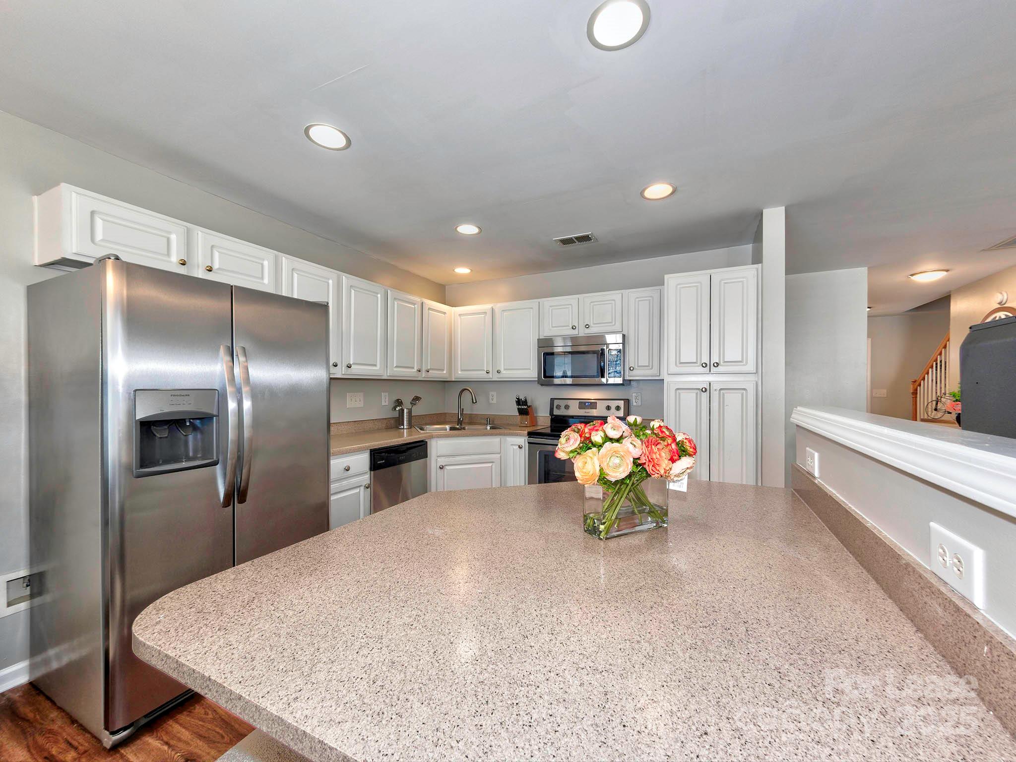 11316 Morgan Valley Lane Charlotte, NC 28270 - Photo 10 of 33 a kitchen view with stainless steel appliances kitchen island granite countertop a sink counter top space and stainless steel appliances