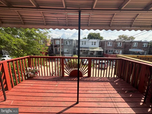 a view of a roof deck with wooden fence and stairs