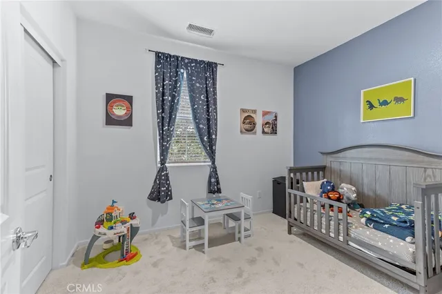 a bedroom with a bed and a couch