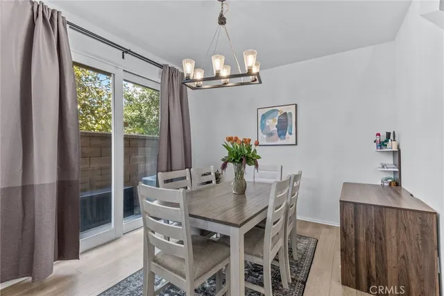 a dining room with furniture a chandelier and window