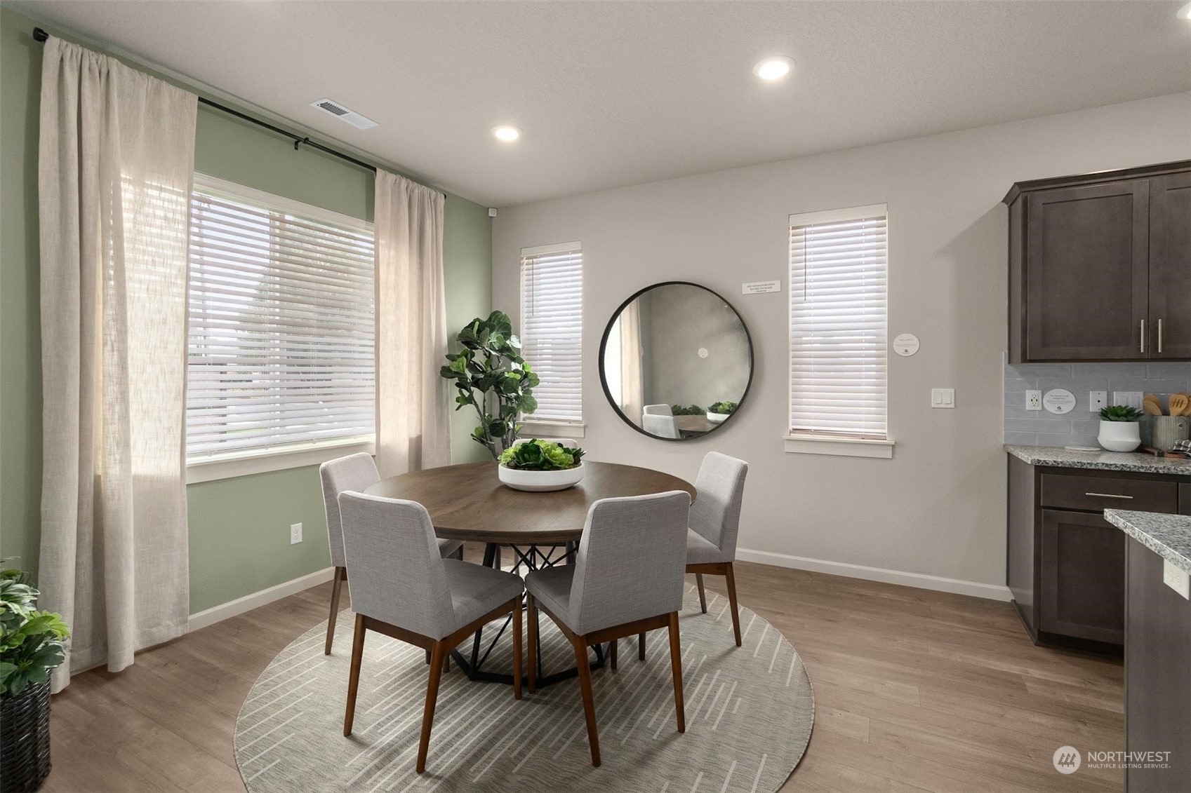 2825 South 6th Way Ridgefield, WA 98642 - Photo 13 of 26 a view of a dining room with furniture a potted plant and wooden floor