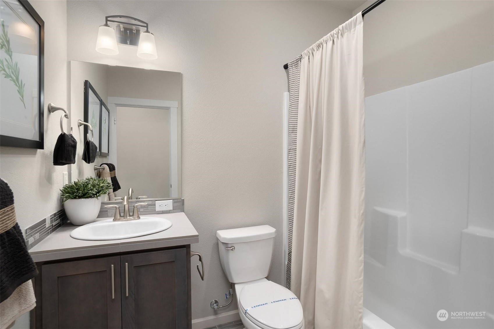 2825 South 6th Way Ridgefield, WA 98642 - Photo 25 of 26 a bathroom with a toilet a sink and mirror
