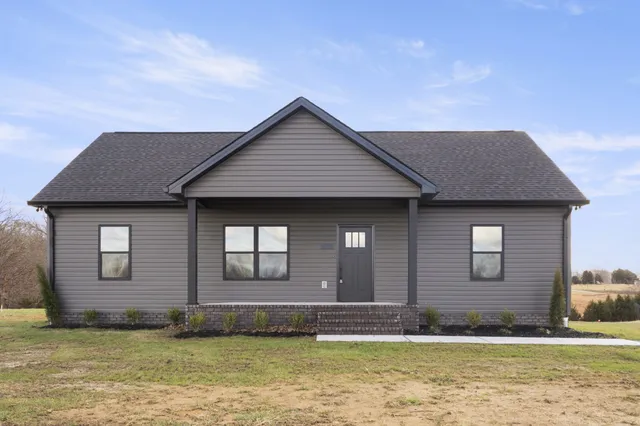 a front view of a house with a garden